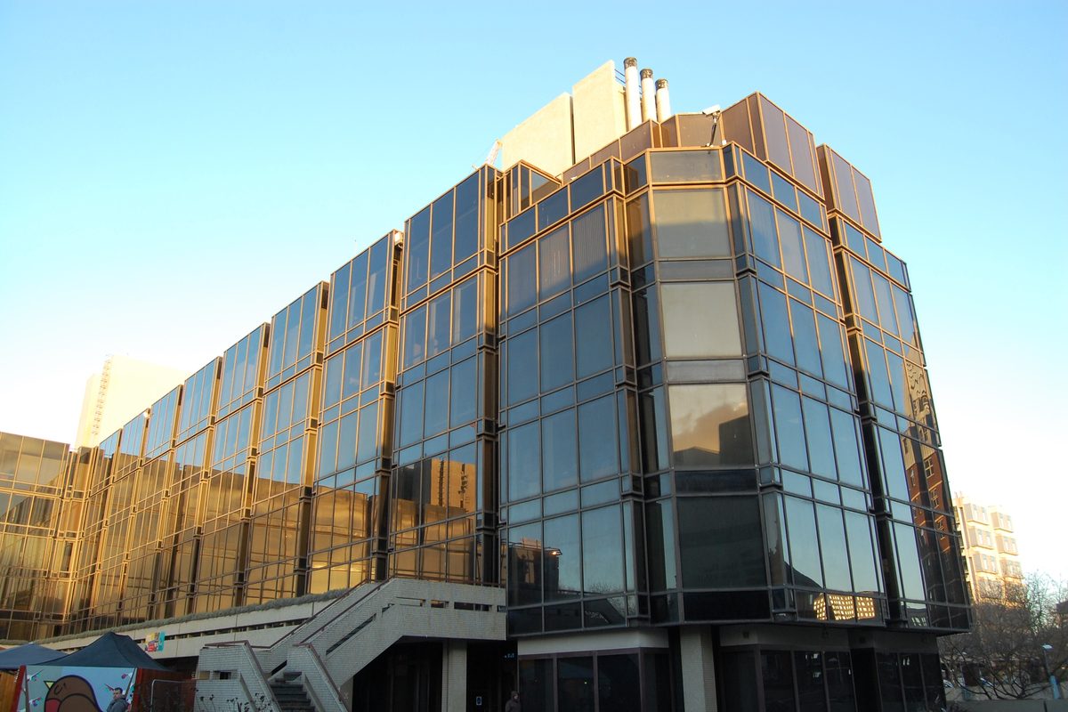 Portsmouth Civic Offices, a 1970s building clad in bronze-tinted glass, lit by low winter sun